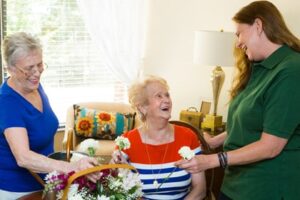 elder women surprised by gift of flowers